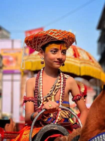 Another young boy embodying the spirit of a Mavala. The bright sunlight and traditional costume make for a powerful and vibrant cultural portrait.