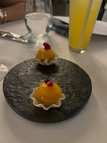 Bite-sized mango spheres served in a delicate pastry cup. This was a special creation for a tasting menu, offering a burst of fresh, fruity flavour.
