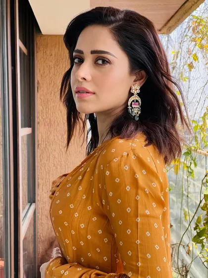 A vibrant bandhani print co-ord set for Nushrratt Bharuccha. This look, featuring a draped top and matching pants with a jacket, is perfect for a festive brunch or a casual wedding event.