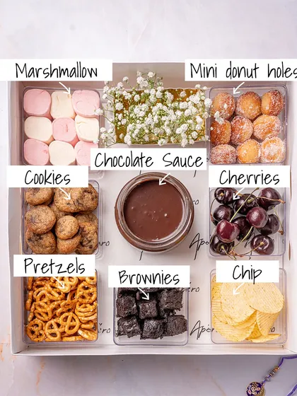 Gifting should be an experience, and our 'Sugar & Strings' chocolate fondue hamper is exactly that. This Rakhi special is packed with everything you need for a fun, indulgent moment: rich chocolate sauce, marshmallows, mini donut holes, brownies, cookies, and more.