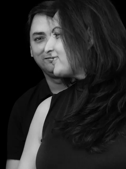 Black and white photography adds a timeless and artistic quality to maternity portraits. This close-up shot uses dramatic lighting to create a powerful image about two people becoming one family.