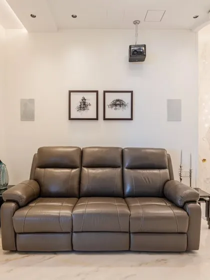 Another view of the home theater, showing its connection to the rest of the home via the grand staircase. The design allows the space to feel both separate and integrated.