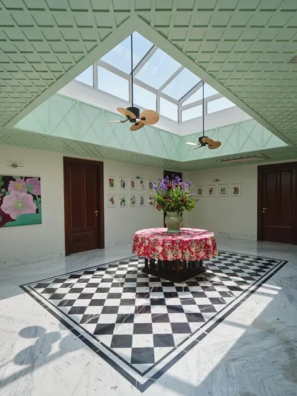 At the heart of The Blooming Garden, the central atrium gathers light, breath, and memory. We designed this inward-looking courtyard with a large skylight and mint-green lattice panels to connect the home's past to its present, creating a space for daily rituals to unfold.