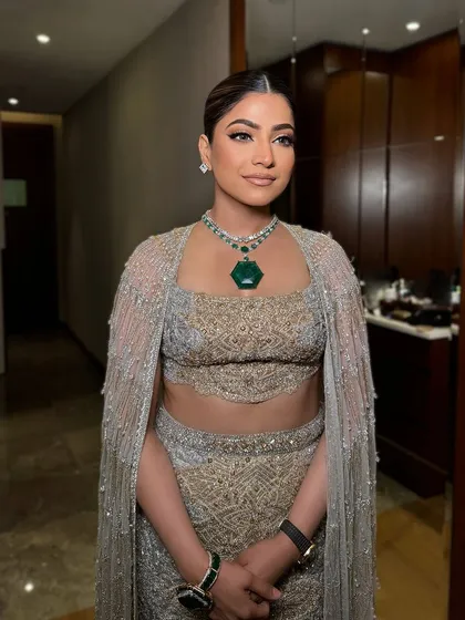 The full look. The simple, elegant makeup allows the statement emerald necklace to be the star of the show.