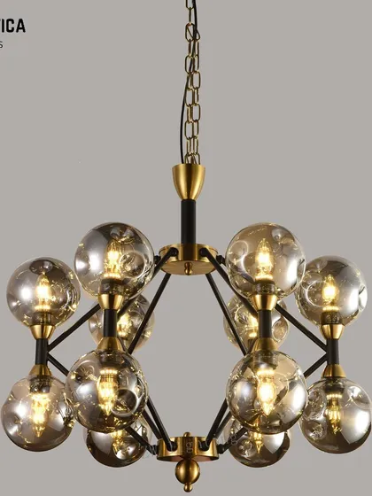 This modern chandelier features a cluster of smoked glass spheres. The design offers beautiful ambient lighting and adds a touch of contemporary elegance to any room's decor.