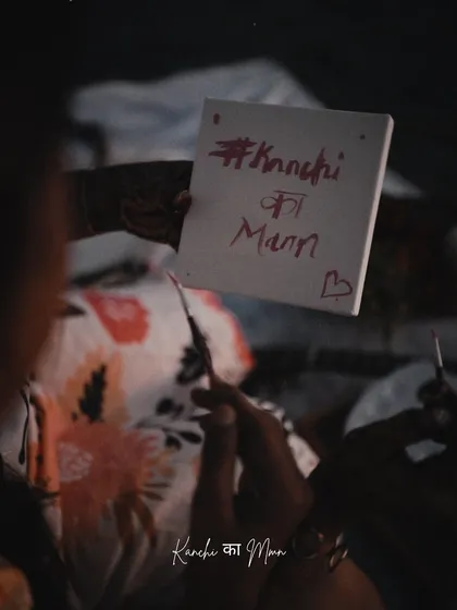 A detail shot that tells a big story. The custom sign with their wedding hashtag, "#KanchiKaMann," is a beautiful and personal touch that we incorporated into their pre-wedding shoot.