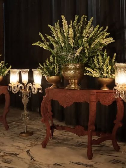 Moody and atmospheric decor details, with classic candelabras and floral arrangements set against a dark backdrop to create a sense of intimacy and mystique.