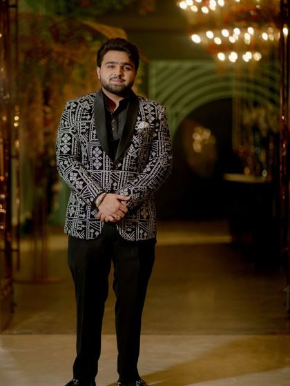 A happy client looking sharp in a black and white patterned tuxedo. This is a perfect look for a reception or party, combining classic colors with a modern print.