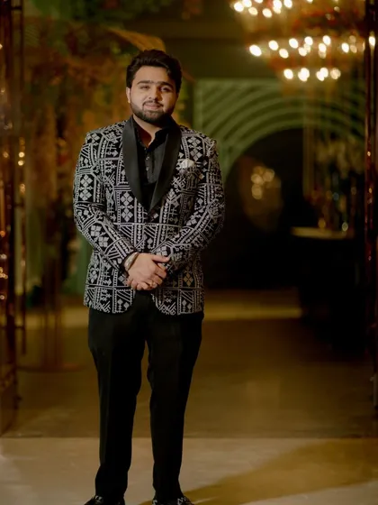 A happy client looking sharp in a black and white patterned tuxedo. This is a perfect look for a reception or party, combining classic colors with a modern print.