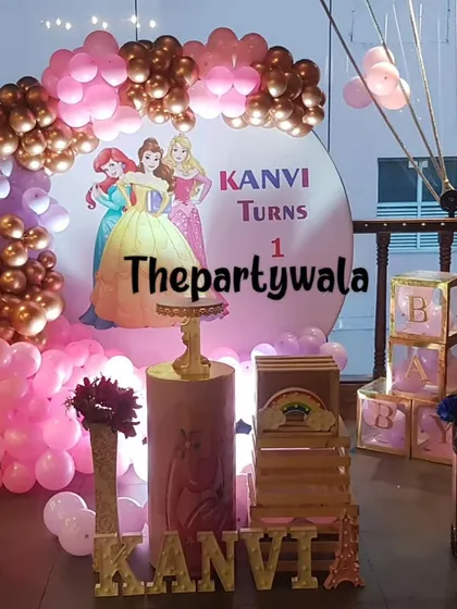A grand princess theme for a first birthday, with a large backdrop and beautiful balloon columns. The pink and rose gold colors are perfect for a royal celebration.