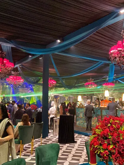 An atmosphere buzzing with energy and elegance. We blend vibrant decor, such as these stunning pink chandeliers, with sophisticated layouts to create a truly dynamic event space.