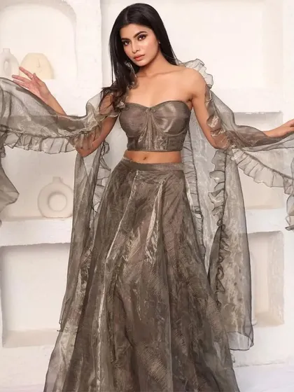 The same metallic organza lehenga, showing the flowing, ruffled dupatta.
