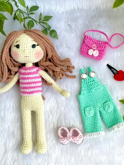 Here are all the pieces for the second outfit: a striped top, mint overalls, bow shoes, a floral bag, and a heart-shaped hair clip. All handmade and designed for little hands to play with.