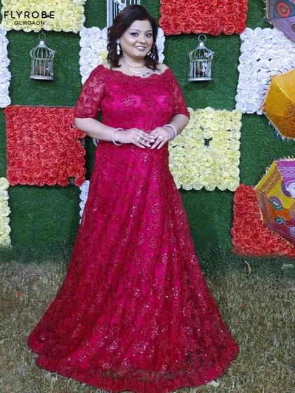 Ready to steal the spotlight at your next cocktail party? This vibrant magenta lace gown is a total showstopper. Look and feel like a million bucks without spending it.
