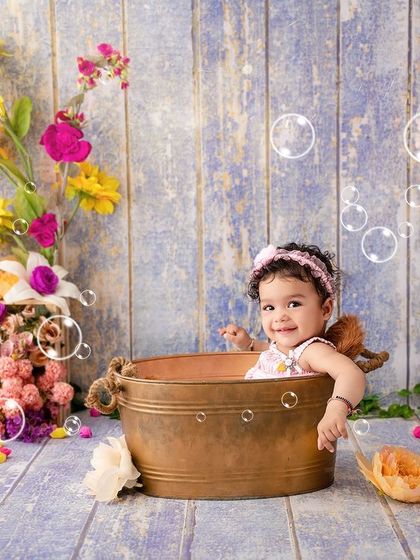 Who loves bubbles? Nine-month-old Mahira certainly does, enjoying her floral-themed bath time shoot.