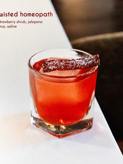 The Twisted Homeopath is a bold and unconventional creation. We blend whisky with a house-made strawberry shrub and a surprising hint of jalapeno brine, resulting in a complex cocktail that is equal parts sweet, savory, and spicy.