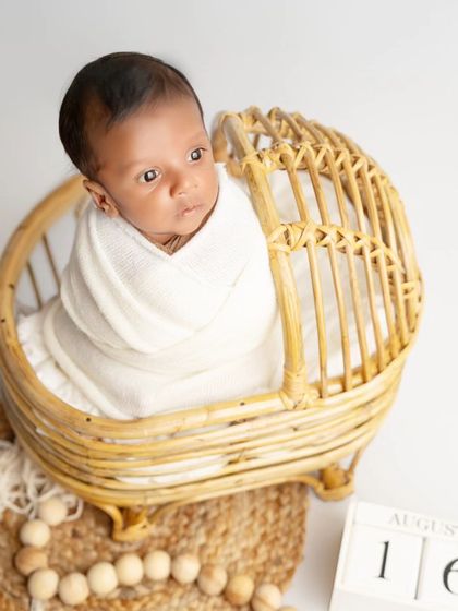 A beautiful moment of a newborn looking curiously at the world from the comfort of his basket. These awake moments are just as precious.