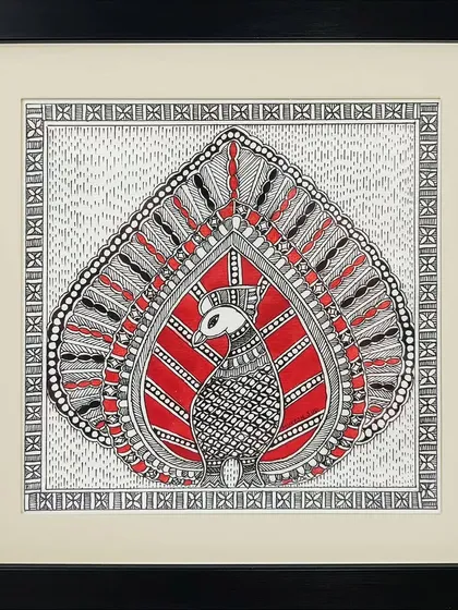 This Madhubani painting by Anu Bansal features a stylized peacock, its feathers forming a leaf-like shape. The bold use of red and black creates a powerful and graphic composition.