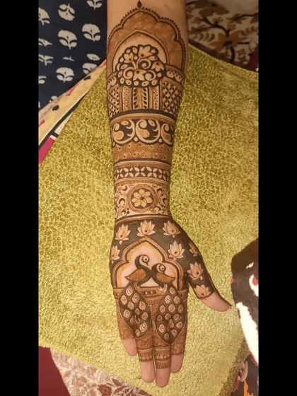 A full-arm engagement design with peacocks, lotuses, and intricate patterns, perfect for celebrating a new beginning.