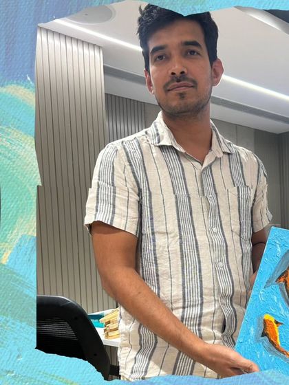 A proud moment for this participant at a company art event, holding up his finished koi fish painting. These workshops are a great way to build confidence and a sense of accomplishment.