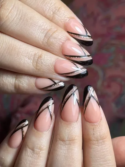For those who love a modern, graphic look. This design uses a sheer nude base on almond extensions to make the sharp black lines and delicate glitter accents pop.