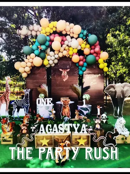 This lush jungle theme for Agastya's first birthday is one of my signature styles. The setup is filled with friendly animal cutouts, rich greenery, and a beautiful balloon arrangement, creating a vibrant and immersive wild adventure for the little one and all the guests.