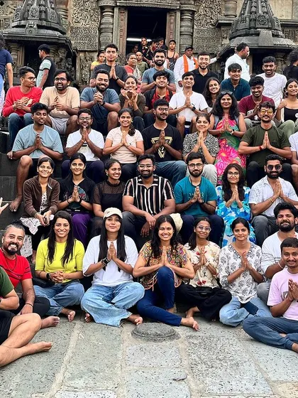 A large group photo at a temple, celebrating the completion of another successful monsoon trek.
