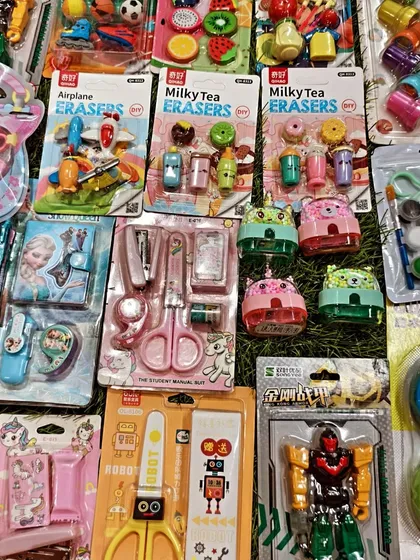 Here is a close up of some of the fun stationery items I have. You can see fruit shaped erasers, robot themed scissors, and small sharpener sets, all great for filling up return gift bags.