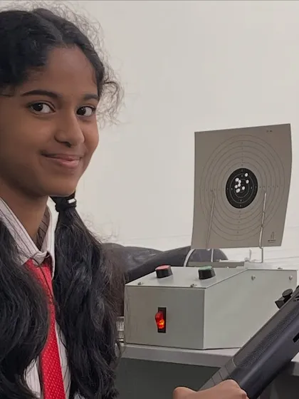 A student from BS International School smiles after a great practice shot. We have partnered with the school to set up a shooting range in the Electronic City area, making the sport more accessible.