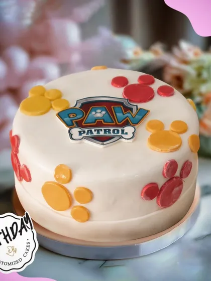 A simple yet fun Paw Patrol cake with the team's logo and colorful paw prints. This fondant-covered cake is a clean and classic choice for a themed party.