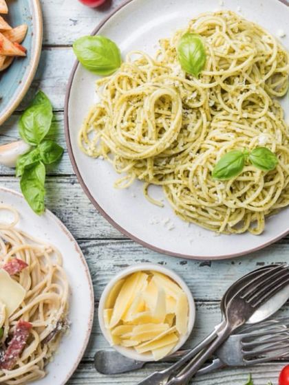 We offer a variety of pasta dishes to suit any taste. This image shows a spread of different pastas, from pesto spaghetti to penne arrabbiata, showcasing our versatility in Italian cuisine.