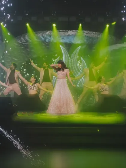 A moment of high drama during the bride's performance, with green lighting and cold pyro effects adding to the spectacle.