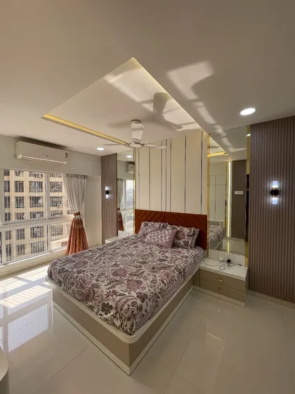 Natural light floods this bedroom, highlighting the clean lines and elegant finishes. The design maximizes both comfort and style.