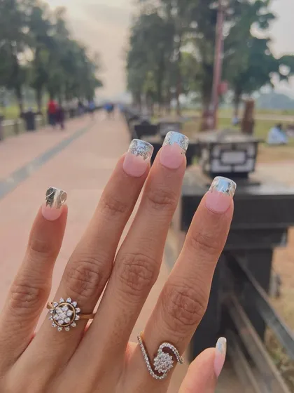 Just go with the flow. This stylish look features a silver metallic French tip on a square-shaped nail for a modern and edgy vibe.