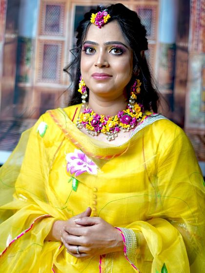 A full portrait of the Haldi bride, looking radiant and happy.