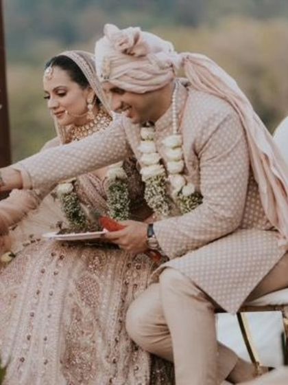 A candid moment during the wedding rituals. The makeup is designed to look flawless and natural throughout the ceremony.