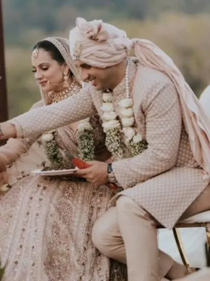 A candid moment during the wedding rituals. The makeup is designed to look flawless and natural throughout the ceremony.
