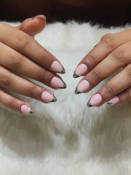 Here’s a modern twist on a classic. These almond-shaped nails feature a soft pink base with a striking silver chrome French tip. It's a chic, clean, and trendy look that elevates any style.