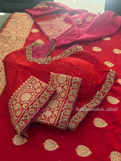A classic red bridal blouse with elegant floral embroidery on the sleeves.