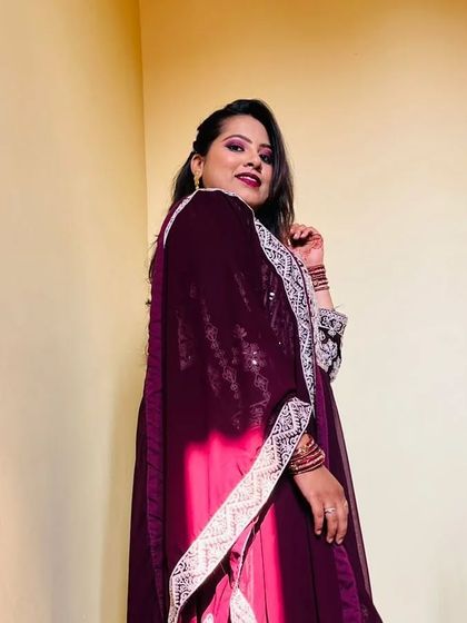 Arshiya looking stunning in her party outfit. The makeup features a dramatic wine-colored eyeshadow and a matching bold lip.