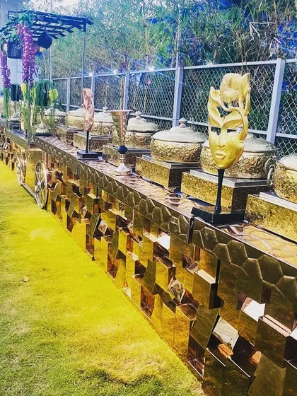 This is a glimpse of a full-scale outdoor buffet line I set up. The grand, golden counters create a stunning visual, promising a feast that is both lavish and impeccably organized, no matter the venue.