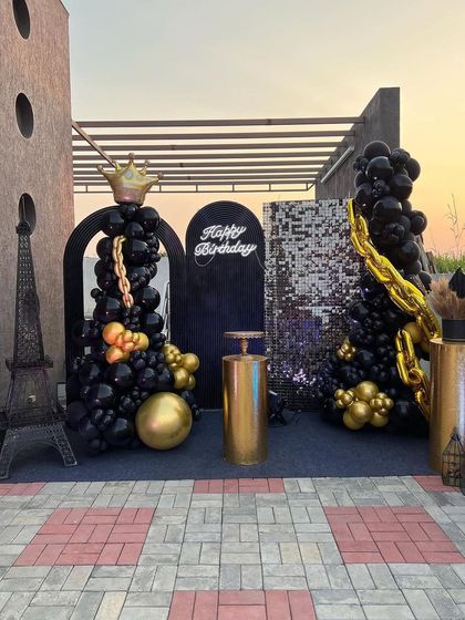 The full terrace setup for the black and gold party at sunset, creating a beautiful and sophisticated party atmosphere.