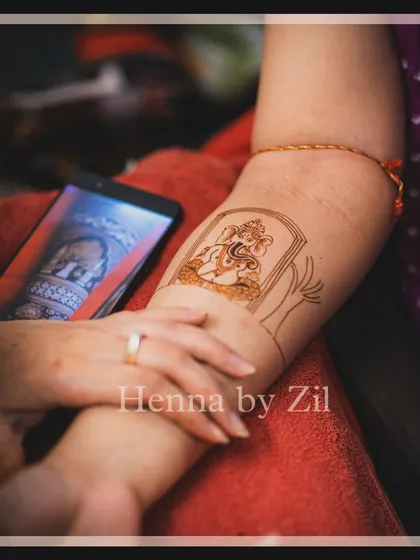 A behind-the-scenes look at creating the Ganesha portrait. You can see how I use a reference image on the phone to ensure the details are captured perfectly, turning the arm into a canvas.