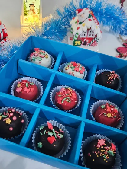 A box of our Christmas-themed rum balls, decorated with colorful sprinkles. A classic holiday treat that our clients request every year.