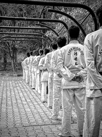 The back of our uniforms shows our commitment to the art of Taekwondo. This is a shot of our students in a disciplined line formation.