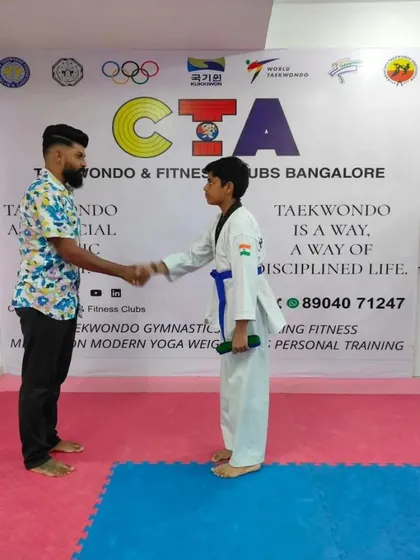 A handshake for a new blue belt.
