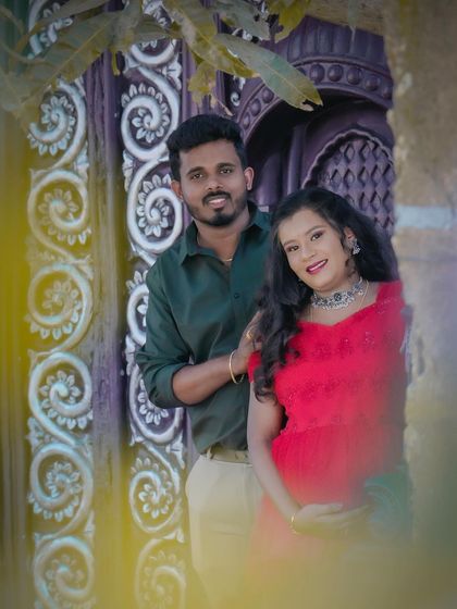 A lovely maternity portrait taken outdoors, using the architectural details of a location to frame the happy couple.