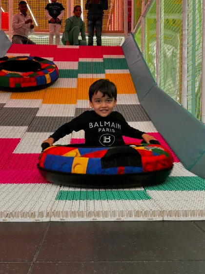 A perfect action shot of a child enjoying our colorful donut slide. This is the kind of pure, simple joy we create every day.