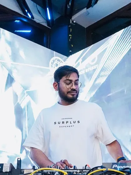 In my element, mixing tracks on my Pioneer DJ setup against a stunning visual backdrop at Flo. I ensure every set is a complete audio-visual experience.