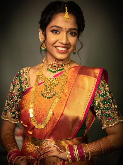 A full-length view of Keshika's stunning muhurtham attire. The makeup was designed to complement the intricate details of her saree and jewellery.